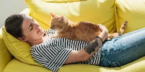 cat sat on womans chest