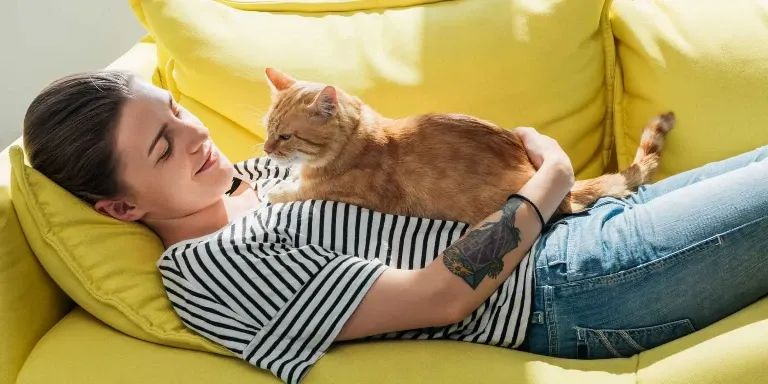 cat sat on womans chest