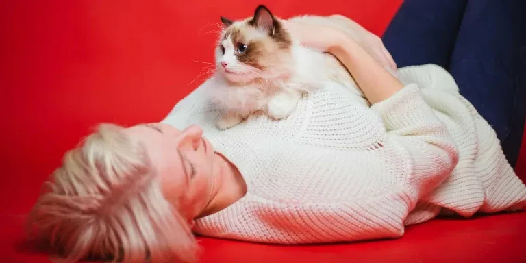 woman with ragdoll cat