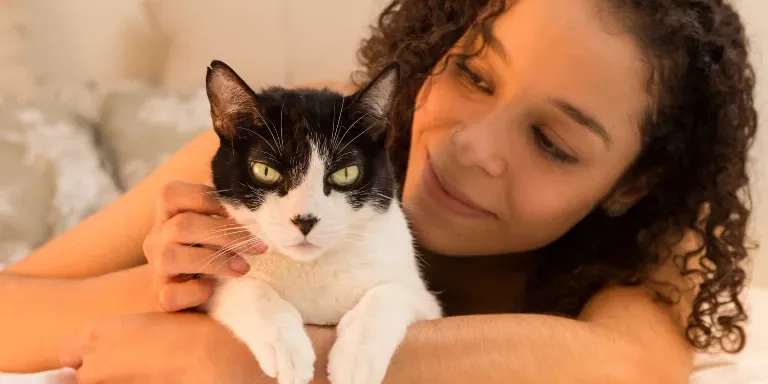 woman looking lovingly at cat