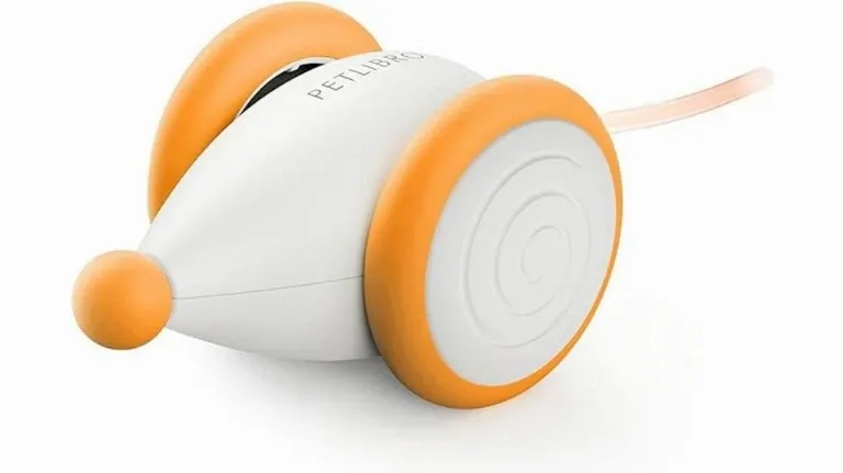 A small orange and white toy on a white surface.